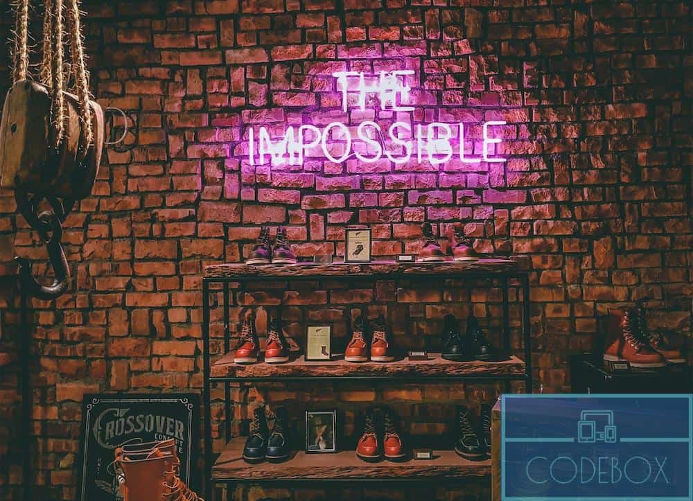 The Impossible neon light signage on brick wall